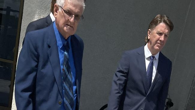 John Charles White (left) and his legal team leaving Beenleigh Magistrates Court.