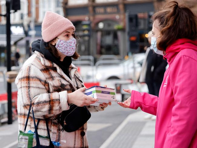 Volunteers hand out boxes of Covid-19 rapid antigen tests in north East London. Picture: AFP