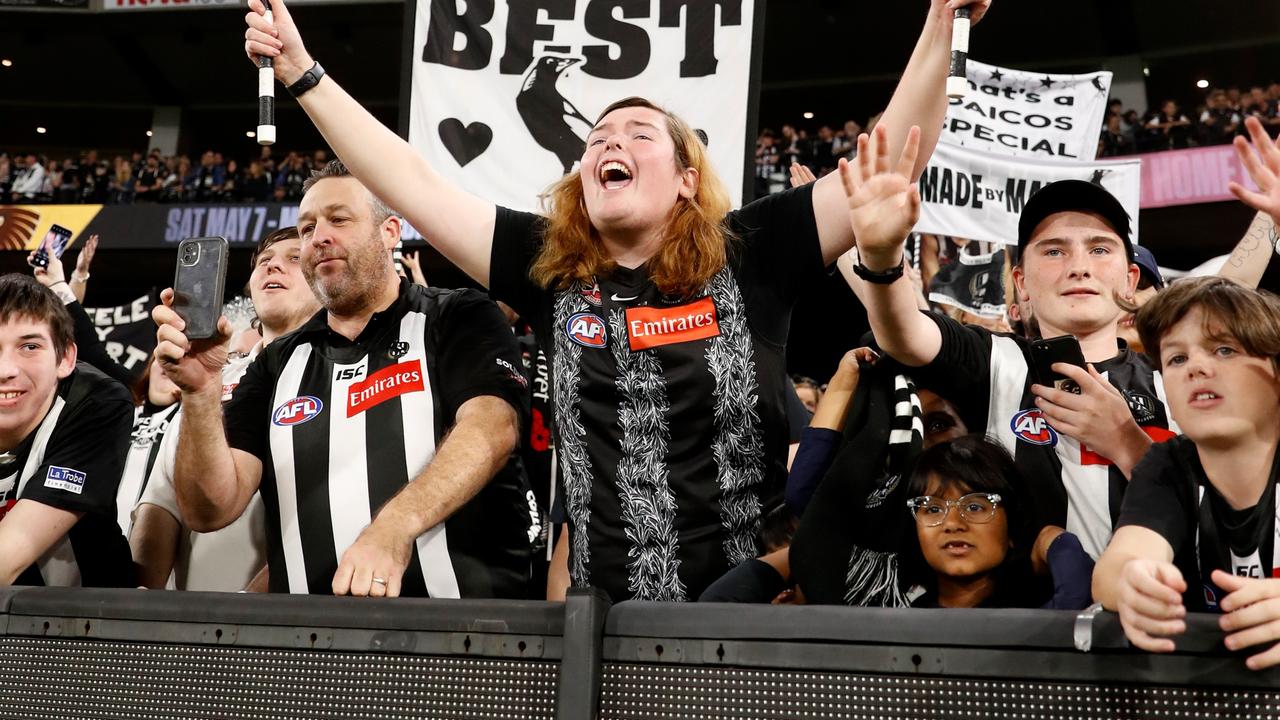 Collingwood fans celebrate their big win over Essendon on ANZAC Day (Photo by Dylan Burns/AFL Photos via Getty Images)