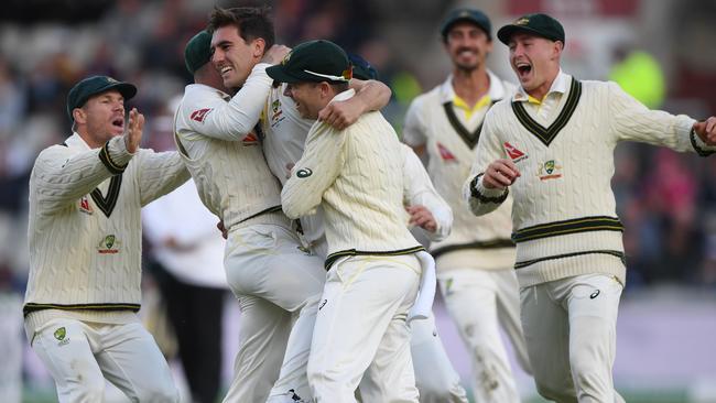 Team-mates mob Pat Cummins. Picture: Getty Images