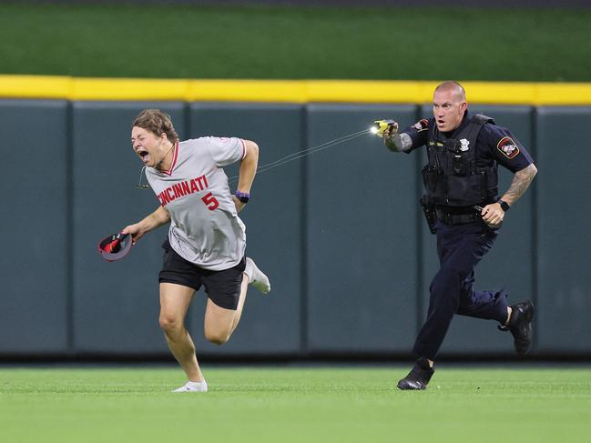 CINCINNATI, OHIO - JUNE 11: An unidentified fan is tased by a police officer as he runs on the field before the ninth inning of the Cincinnati Reds against Cleveland Guardians at Great American Ball Park on June 11, 2024 in Cincinnati, Ohio.   Andy Lyons/Getty Images/AFP (Photo by ANDY LYONS / GETTY IMAGES NORTH AMERICA / Getty Images via AFP)