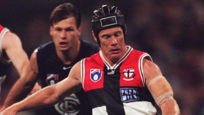 St Kilda champion Nathan Burke gets a kick away during his playing career.