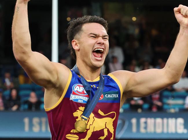 Cam Rayner celebrates after receiving his premiership medal on the dais. Picture Lachie Millard