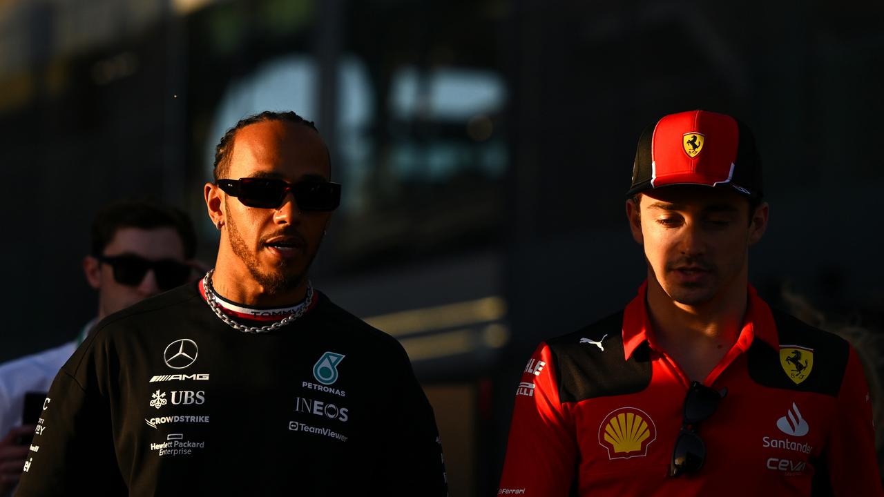 JEDDAH, SAUDI ARABIA - MARCH 16: Lewis Hamilton of Great Britain and Mercedes and Charles Leclerc of Monaco and Ferrari talk in the paddock during previews ahead of the F1 Grand Prix of Saudi Arabia at Jeddah Corniche Circuit on March 16, 2023 in Jeddah, Saudi Arabia. (Photo by Clive Mason/Getty Images)