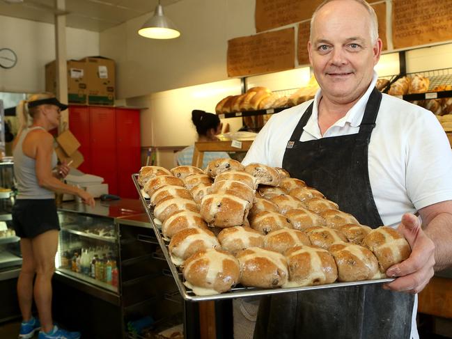 Owner and baker at Brewbakers, Richard Cotton, poses with Hot Cross Buns in Brisbane, Wednesday, April 3, 2019. Brewbakers is attempting for the first time to make sourdough hot crossed buns. (AAP Image/Jono Searle)