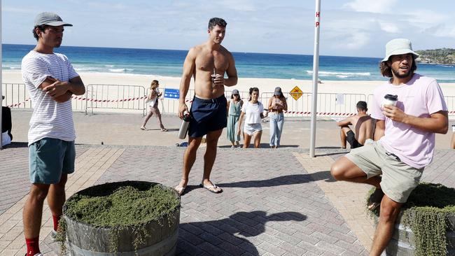 Tommy Harvey, Mario Podesta and Cosme Beamonte enjoy coffee at Bondi Beach a week after Bondi Beach was shut down by the NSW state government. Picture: Nikki Short