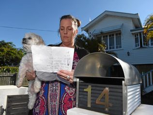 POISONED PET: Tracey Spoor and her surviving dog Yoppy with the letter she received threatening her dog and children. Picture: Cody Fox