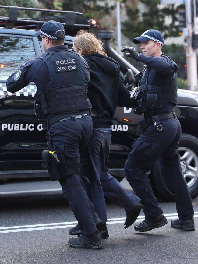 Police arrest one of the protesters. Picture: John Grainger