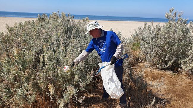 John Forrester picks up rubbish from the South Werribee beach foreshore. Picture: Athos Sirianos