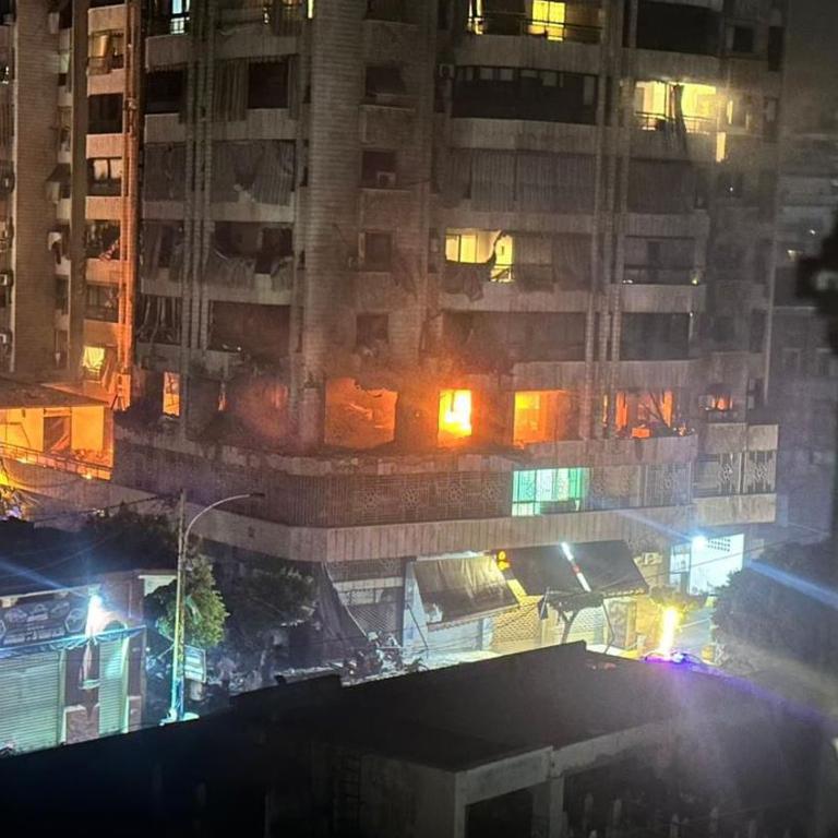 A residential building in the suburb of Dahiyeh is seen on fire after a missile strike.