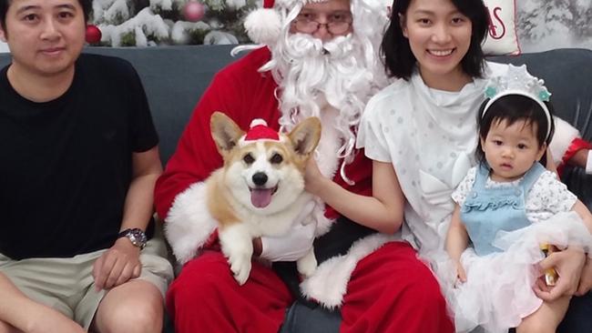 The Pham family with their beloved and now missing corgi Haku.