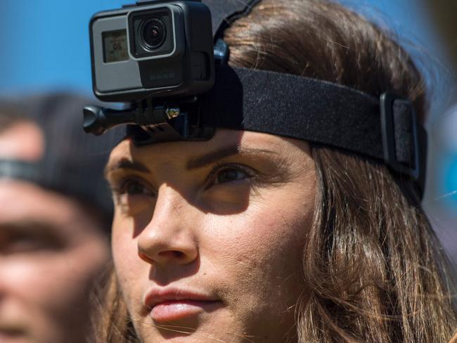 Morgan Brechler (R) listens to a training demonstration while wearing a GoPro HERO5 Black on her head during a press event in Olympic Valley, California on September 19, 2016. / AFP PHOTO / JOSH EDELSON