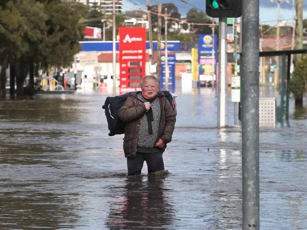 A man leaves his house on Raleigh Rd in Maribyrnong during the 2022 floods. Picture: David Crosling