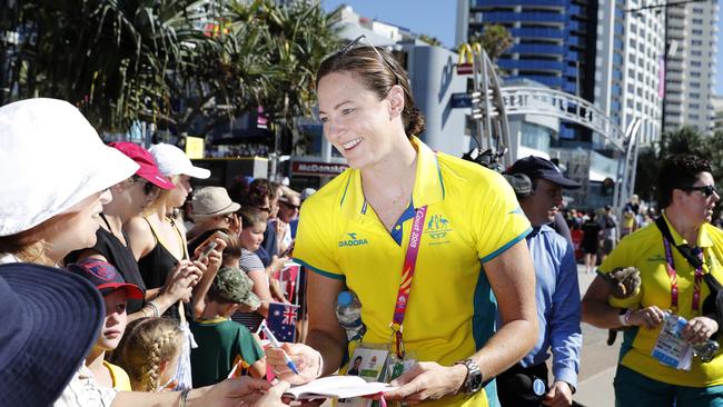 Swimmer Cate Campbell signs autograph for waiting fans as she arrives with the Australian Commonwealth Games team for a public event on Surfers Paradise, Gold Coast, Monday, April 16, 2018. (AAP Image/Regi Varghese) NO ARCHIVING