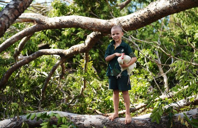 Levi Mitchell, 7 and Moonlight the chicken wander through the tropical wasteland left by Cyclone Marcus. Picture: Keri Megelus