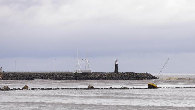 A Yacht and silage bales washed up at the mouth of the Mersey River. Picture: Grant Viney