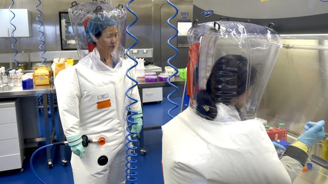 Virologist Shi Zheng-li, left, works with her colleague in the P4 lab of Wuhan Institute of Virology (WIV) in Wuhan. Picture: Getty Images.