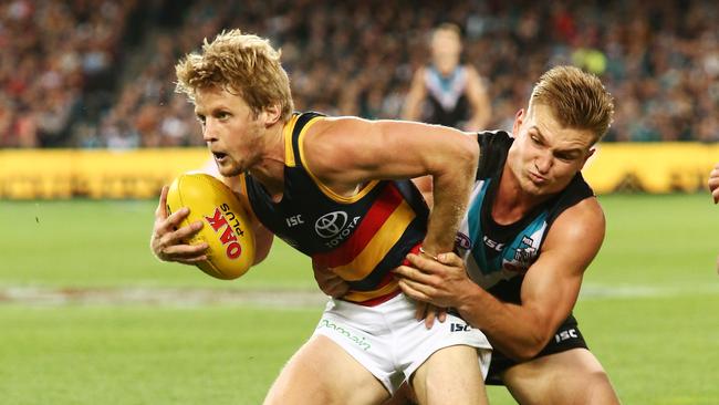 Crows Rory Sloane is tackled by Port Adelaide’s Ollie Wines at Adelaide Oval on April 8, 2017. Picture: Morne de Klerk/Getty