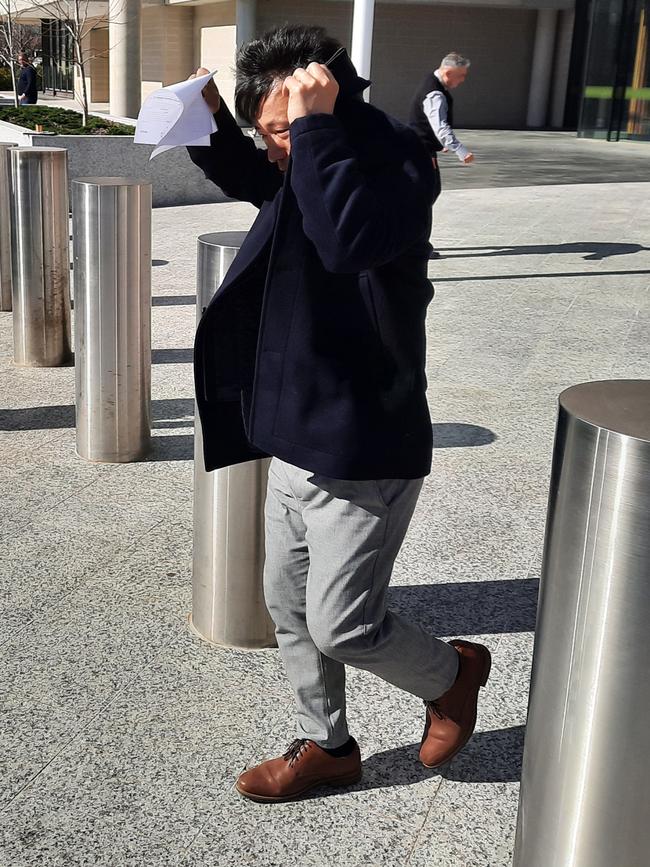 Kyong Shik Choi, also known as Kenny Choi, leaves the ACT Magistrates Court after being charged with the assault of a child. Picture: Craig Dunlop