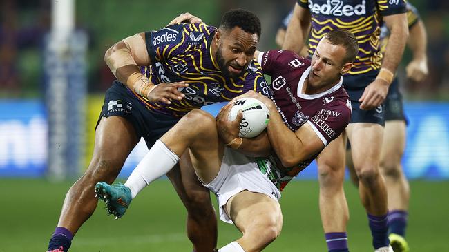 Melbourne’s Justin Olam is tackled by Manly’s Daly Cherry-Evans. Picture: Daniel Pockett/Getty Images