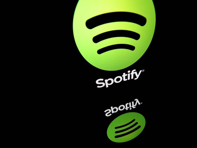 (FILES) In this file photo illustration taken on April 19, 2018 shows the logo of online streaming music service Spotify displayed on a tablet screen in Paris. - Shares of Spotify tumbled February 2, 2022 after the music streaming service reported a quarterly loss and projected lower profit margins in the coming earnings period. (Photo by Lionel BONAVENTURE / AFP)