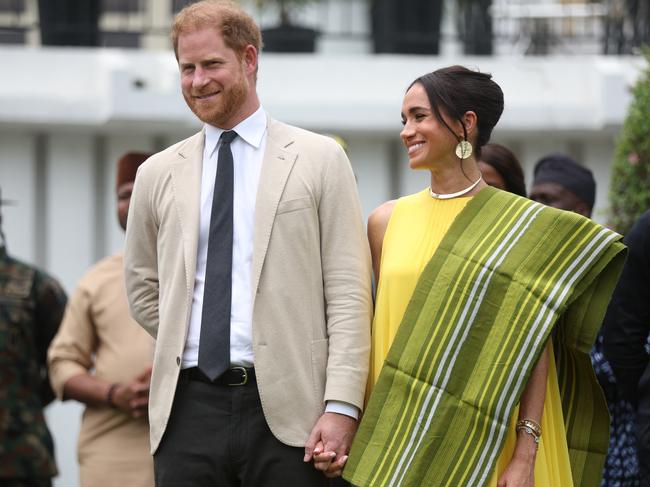 Britain's Prince Harry (2ndR), Duke of Sussex, and  Britain's Meghan (R), Duchess of Sussex, react as Lagos State Governor, Babajide Sanwo-Olu (unseen), gives a speech at the State Governor House in Lagos on May 12, 2024 as they visit Nigeria as part of celebrations of Invictus Games anniversary. (Photo by Kola SULAIMON / AFP)