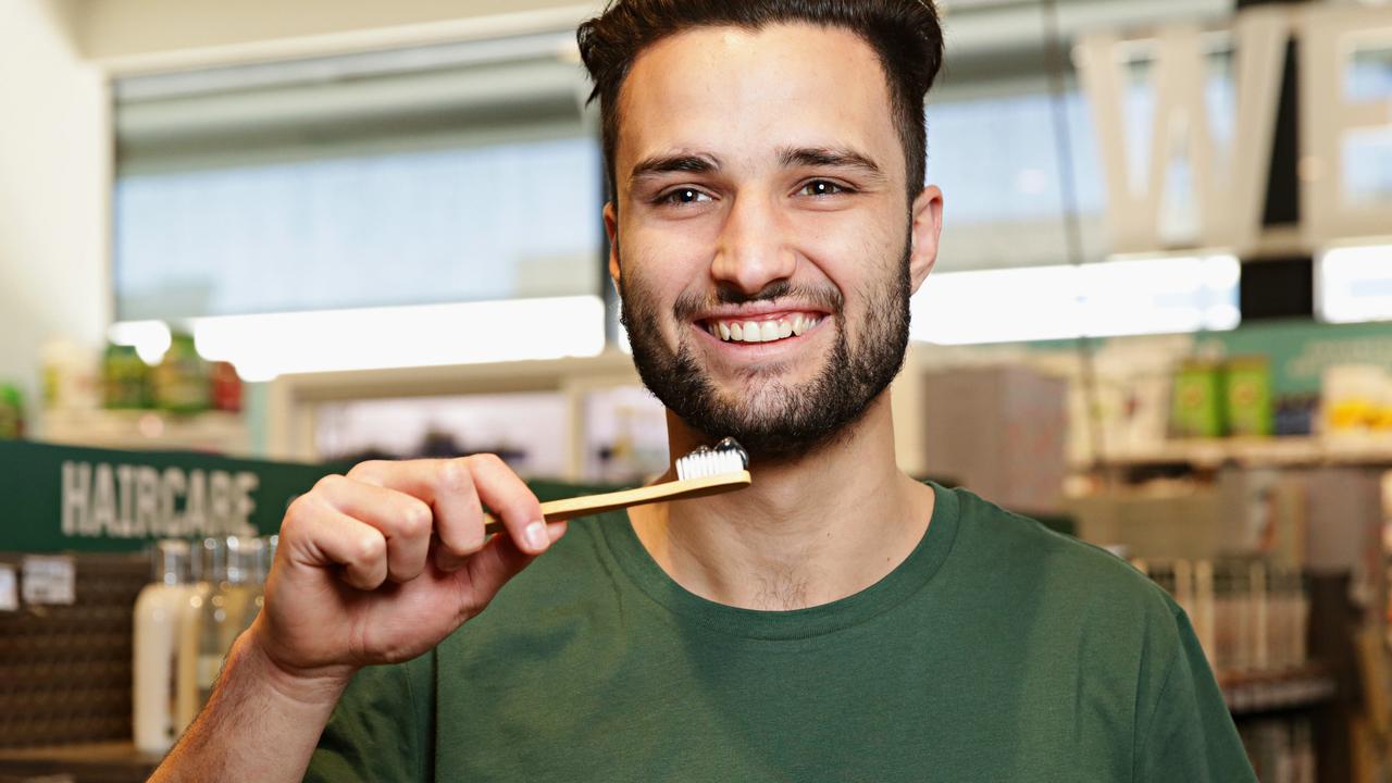 Mason Ireland, of Flannerys Mona Vale, poses with charcoal toothpaste, a new health fad at Flannerys. Picture: Adam Yip