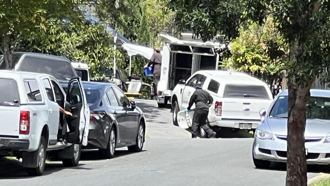 Police officers pictured outside the Pacific Pines home. Photo: Keith Woods.