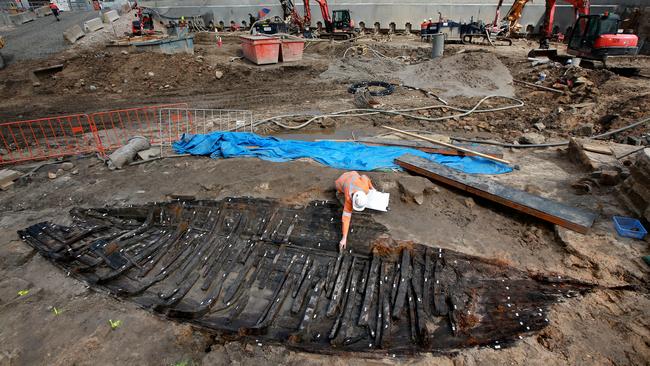 Archaeologists worked delicately to uncover and extract the remains in the state’s oldest boat unearthed during construction of the Sydney Metro station at Barangaroo. Picture: Toby Zerna