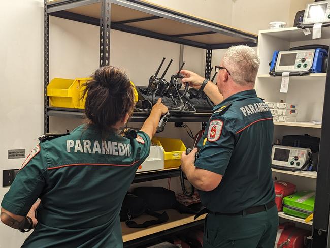 St John Ambulance NT director of ambulance services Andrew Thomas and duty officer Sam Cooper equipping themselves for a busy Friday night shift. Picture: Alex Treacy