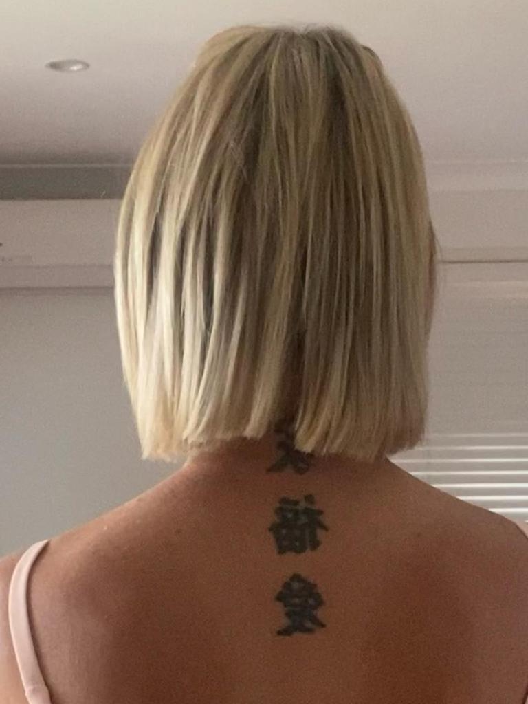 Ms Hally said the three tattoos in Chinese lettering on her upper back translated to “family, love, and happiness.” Picture: Facebook