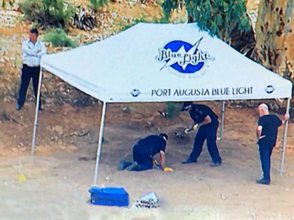 Police were seen excavating the shallow grave in the Flinders Ranges, north of Hawker, on Monday. Picture: 7 News