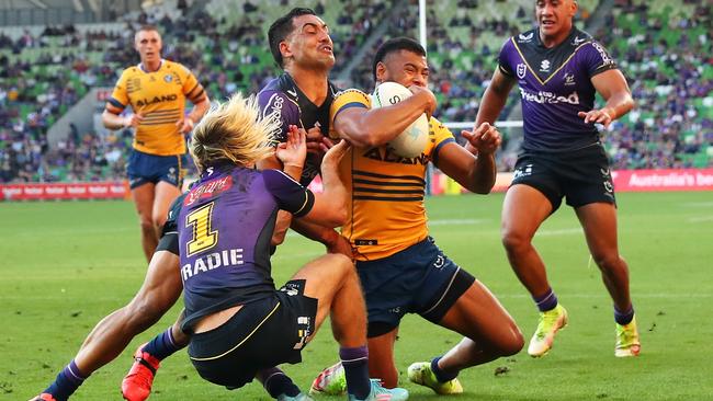 Waqa Blake bowls over Ryan Papenhuyzen to score for the Eels. Picture: Kelly Defina/Getty Images