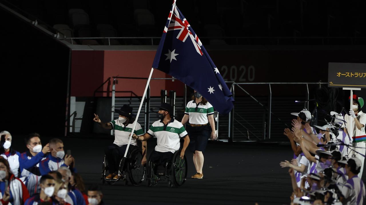 Flag bearers Lisa Daniela Di Toro and Ryley Batt of Team Australia lead their delegation in the parade of athletes during the opening ceremony of the Tokyo 2020 Paralympic Games.