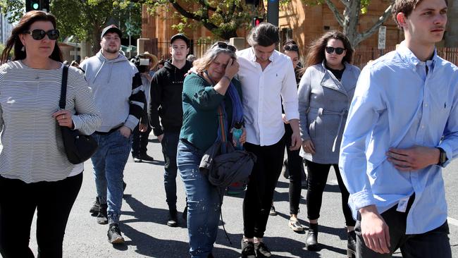 Julie Kelbin, the mother of Jack Hanley, is comforted by friends and family outside the Adelaide Magistrates Court. Picture: AAP/Kelly Barnes