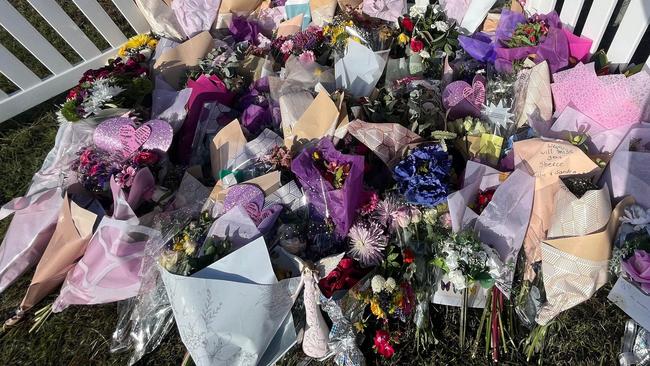 A fence has been placed around the floral tributes dedicated to three people who lost their lives in a crash in Maryborough.