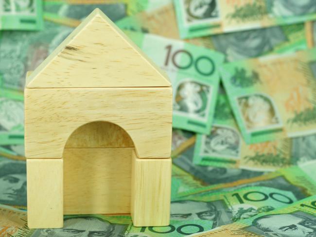 Wooden block house on a background of $100 notes, Australian money housing generic