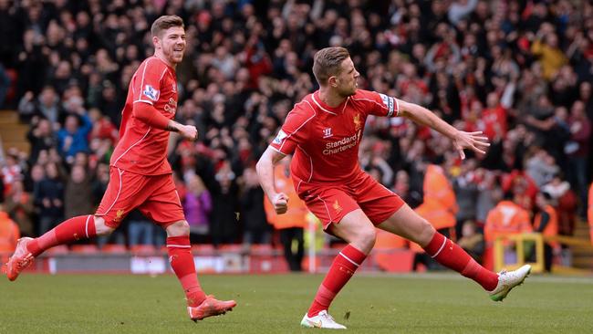 Liverpool's English midfielder Jordan Henderson (R) celebrates.