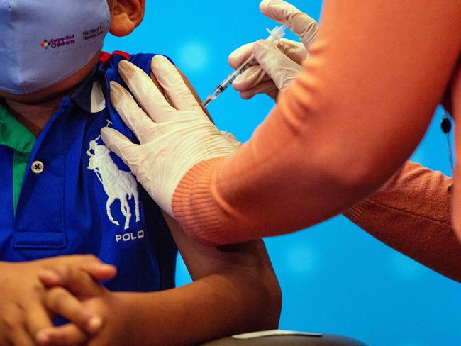 A six-year-old child receives the Pfizer-BioNTech Covid-19 Vaccine for 5-11 year old kids before it was approved for the younger age group. Picture: AFP.