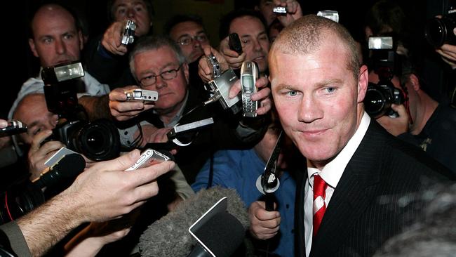 Barry Hall is mobbed by the media after avoiding suspension for striking Matt Maguire.