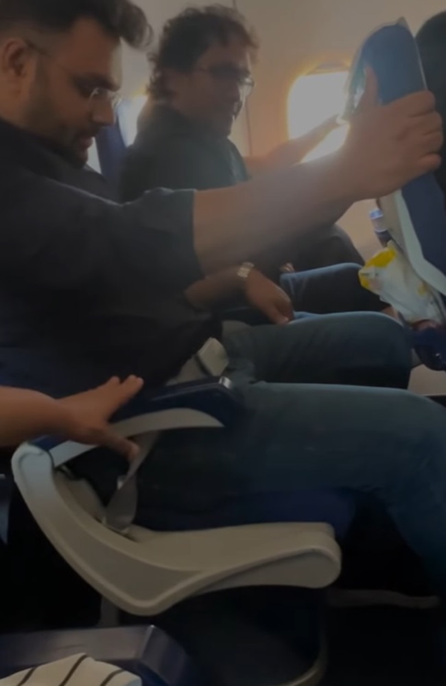 Passengers grip onto the seats in front after their row suddenly started swaying back and forth. Picture: Instgram/thewolfofjobstreet