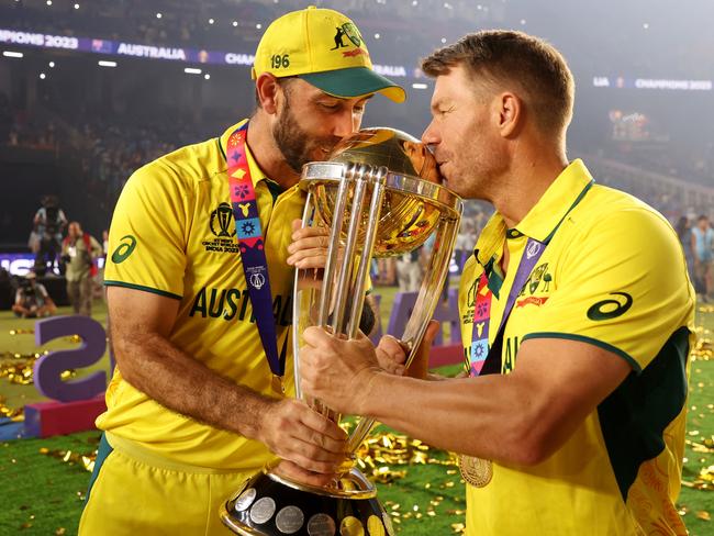 AHMEDABAD, INDIA - NOVEMBER 19: Glenn Maxwell and David Warner of Australia poses with the ICC Men's Cricket World Cup Trophy following the ICC Men's Cricket World Cup India 2023 Final between India and Australia at Narendra Modi Stadium on November 19, 2023 in Ahmedabad, India. (Photo by Robert Cianflone/Getty Images)