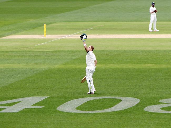 Steve Smith salutes the late Phil Hughes after his century in 2014.