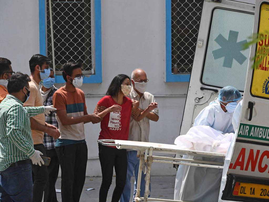 People try to console a woman mourning for the death of her relative in New Delhi. Picture: Tauseef Mustafa