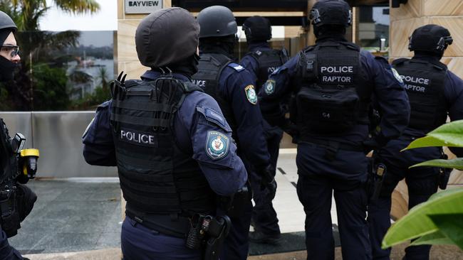 Police descended on the waterfront suburb on Thursday evening. Picture: Jonathan Ng