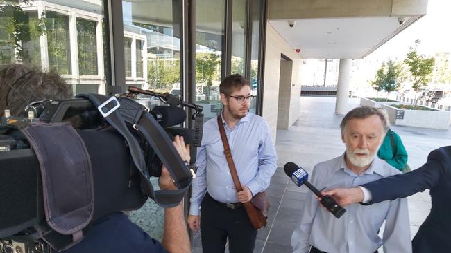 James Michael Waugh (with bag over shoulder) leaves the ACT Magistrates Court after pleading guilty to threatening to kill groups of two Canberra Christian churches. Picture: Craig Dunlop