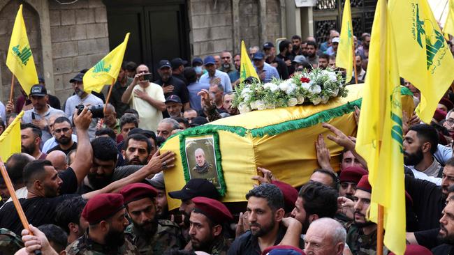 People take part in the funeral of Hezbollah Military Commander Mohammed Naameh Nasser, also known as "Hajj Abu Naameh", in the southern suburb of Beirut.