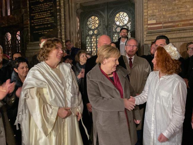 German Chancellor Angela Merkel greets member of the Jewish community at a vigil outside the New Synagogue in Berlin. Picture: AFP