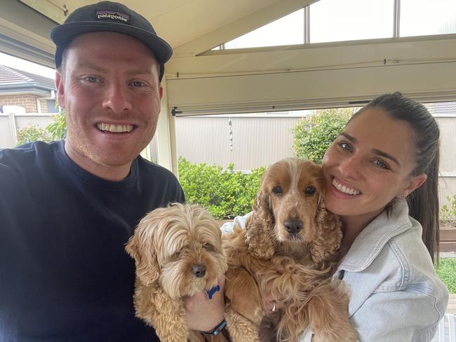 Lachlan Carter (left), of Grasmere, with his sister Ally Carter and their pet cocker spaniel Goldie, and cavoodle Teddy, on Saturday. It was the day after Goldie had been found after she had been missing for six days. Goldie became the focus of an intense local social media 'lost' campaign that attracted more than 7000 engagements and had hundreds of people out searching for her. Picture: Supplied