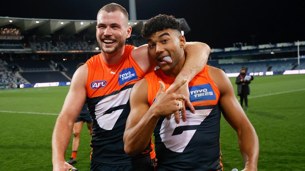 Kieren Briggs and Callum Brown celebrate the Giants’ huge upset against Geelong.